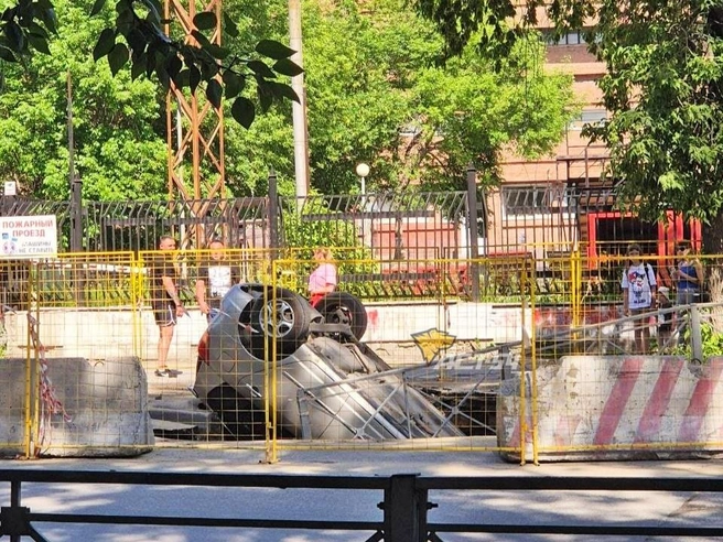 Автомобиль провалился в асфальт на улице Мичурина | Источник: АСТ-54 / vk.com/act54