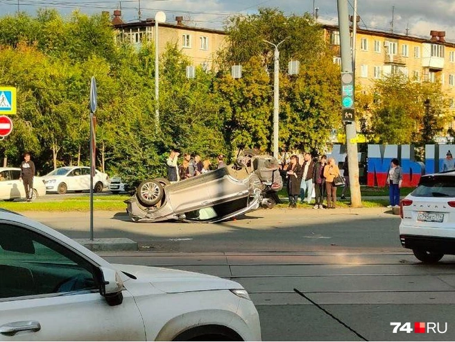 Вокруг перевернувшейся машины толпятся люди | Источник: читатель 74.RU