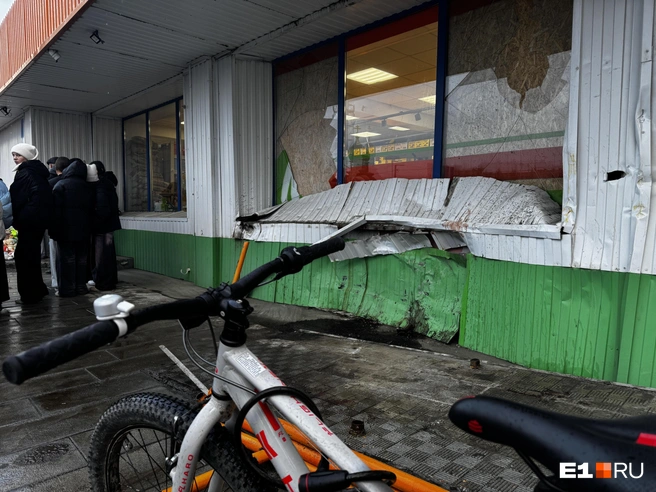 В магазине наспех сделали ремонт, закрыв разбитые окна фанерой, но осталась большая вмятина в стене | Источник: Кирилл Кушнов / E1.RU