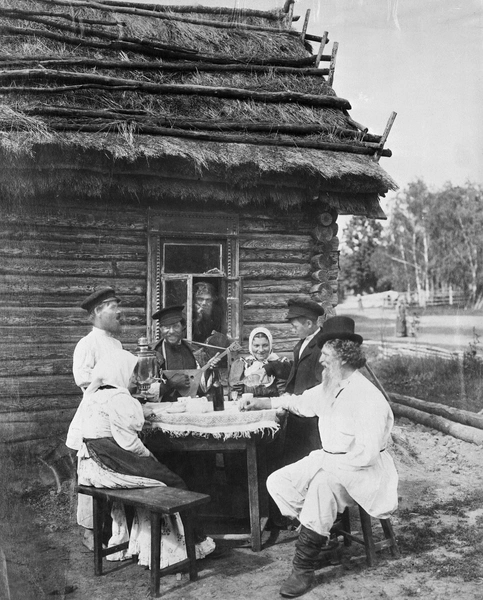 Группа русских крестьян отдыхает, пьет и слушает балалайку. Ок. 1909 год. | Источник: Bettmann/Getty Images