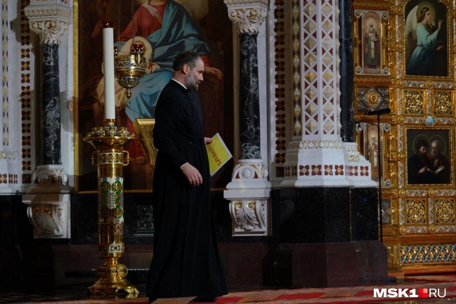 Священнослужители раскладывают у алтаря таблички | Источник: Анна Селина / MSK1.RU