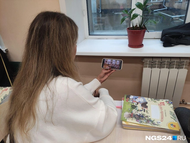 Так родители смотрят на торжественную линейку, находясь в школе | Источник: NGS24.RU