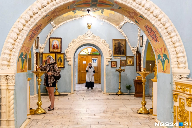 Место, где стоит женщина в белом, и есть та самая пристройка, над которой скрыто изображение | Источник: Мария Ленц / NGS24.RU