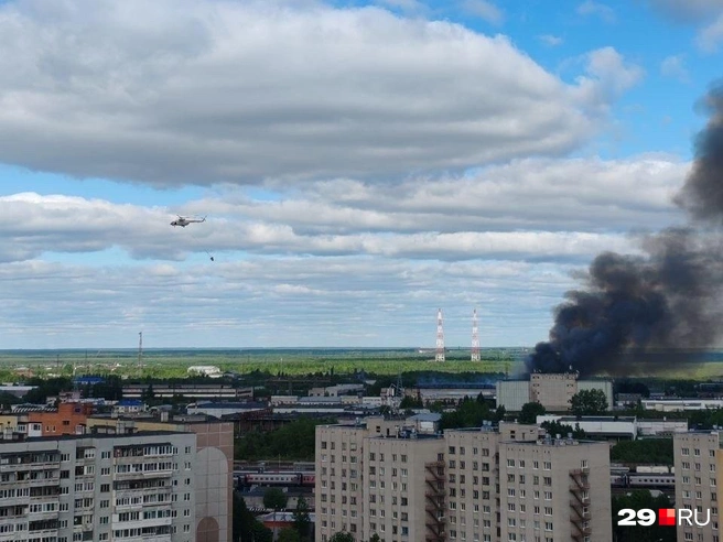 Вертолет выливает воду на горящий склад | Источник: читатель 29.RU