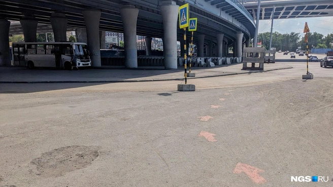Стрелочки предлагают идти прямо туда, в сумерки подмостовья, и теряются где-то в асфальте под эстакадой | Источник: Лиза Пичугина / NGS.RU