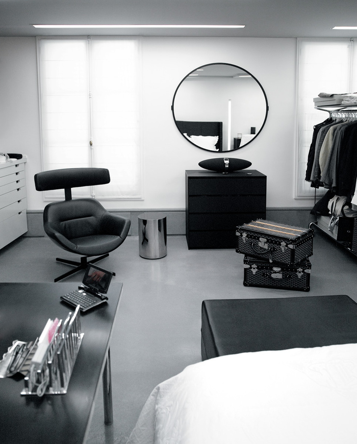 В гардеробной хозяина есть место для рабочего стола, кресла и ноутбука. На полу чемоданы марки Goyard.