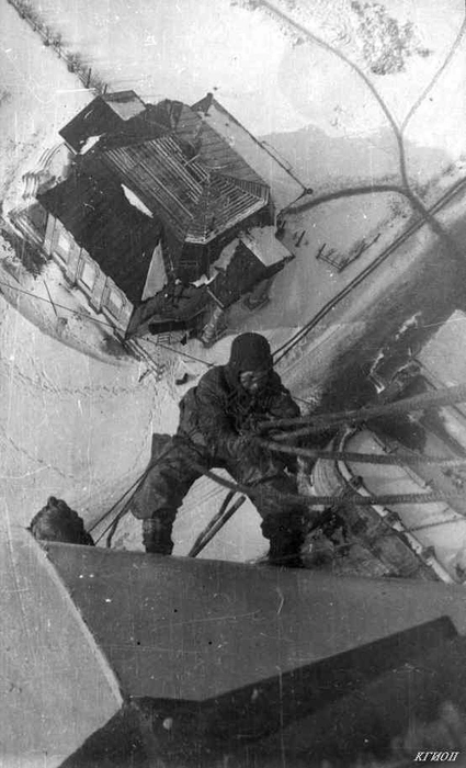 Верхолаз М.&nbsp;И.&nbsp;Шестаков выполняет маскировочные работы на шпиле Петропавловского собора. Март 1943 года. Фотограф Давыдов С.Н. | Источник: КГИОП