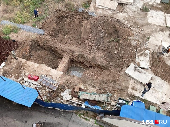 Место несостоявшейся стройки бизнес-центра разрыто прямо под окнами соседних домов | Источник: читатель 161.RU