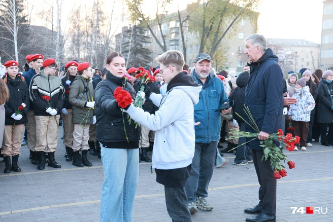 У всех в руках розы и гвоздики | Источник: Михаил Шилкин