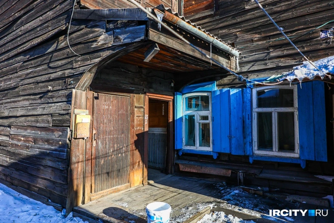 Внушительное деревянное крыльцо, над которым закреплен водосток, а под ним — ведра. Весной тут наверняка потопы | Источник: Ксения Филимонова / «ИрСити»