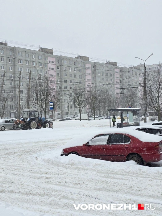 Один дворник пытался раскидать снег у остановки, трактор несся мимо | Источник: Ирина Булгакова/ Voronezh1.ru