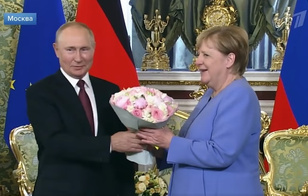 Путин снова подарил Меркель розы и пионы: что он имел в виду?