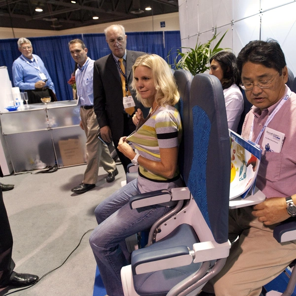 2010 год, посетители выставки Aircraft Interiors Expo Americas в Калифорнии оценивают вертикальные сиденья с шагом 23 дюйма (чуть более 58 сантиметров). Это одна предыдущая версия SkyRider | Источник: Legion Media