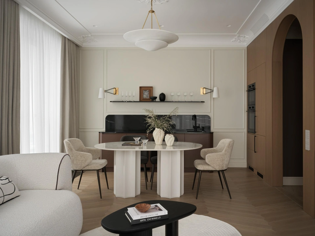 Диван, Сomo casa. Стол, Carincasa. Стулья, Calligaris. Ковер, KulturaKovrov. Люстра над столом и бра над кухней, Visual comfort. Столики, Reloft home. Кухня, столярное оформление стены в шпоне дуба, тумба под тв изготовлены на столярном производстве Balcon studio по эскизам дизайнера | Источник: Ник Руденко. Стилист: Екатерина Наумова