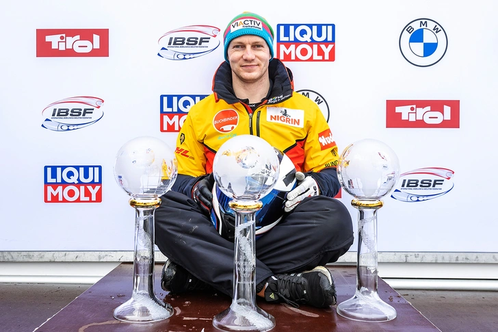 Germany's Francesco Friedrich poses with the three crystal balls for the victory in the two-man, four-man bobsleigh and overall World Cup bobsleigh during the winner ceremony of IBSF World Cup at the Olympic Ice Track in Innsbruck/Igls, Austria, on January