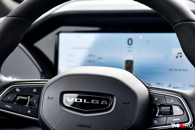 Слово Volga пришлось вписывать в «дельту» логотипа Geely. Цифровая приборная панель сумбурна, но выручает проекционный дисплей | Источник: Артем Краснов