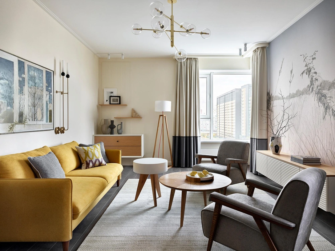 Гостиная. Диван, SK Design. Кресло, Dantone Home. Подвесная тумба и полки сделаны по эскизам дизайнера в мастерской Андрея Александрова. Над тумбой графика Ярослава Селезнева. Журнальный столик и торшер, Yaratam Design. Второй столик сделан по эскизам дизайнера в столярной мастерской @mwood163. Над диваном работа Ирины Зюськиной, галерея Reloft Art. На противоположной стене панно Екатерины Рожковой, Hygge Wall. Центральный светильник и бра, Aromas del Campo. Ковер ручной работы, «Культура ковров». | Источник: Сергей Ананьев. Стиль: Дарья Соболева