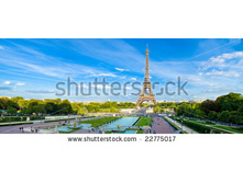 Stock-photo-eiffel-tower-panorama-with-cloudy-blue-sky-and-surrounding-park-22775017.jpg