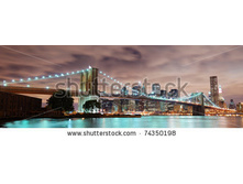 Stock-photo-new-york-city-manhattan-panorama-view-with-brooklyn-bridge-at-night-with-office-building-74350198.jpg