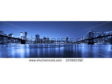 Stock-photo-view-of-manhattan-and-brooklyn-bridges-and-skyline-at-night-103995392.jpg