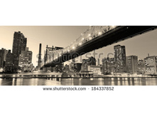 Stock-photo-queensboro-bridge-over-new-york-city-east-river-black-and-white-at-night-with-river-reflections-and-184337852.jpg