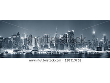 Stock-photo-new-york-city-manhattan-midtown-skyline-black-and-white-at-night-with-skyscrapers-lit-over-hudson-128313752.jpg