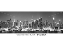 Stock-photo-new-york-city-manhattan-midtown-skyline-black-and-white-at-night-with-skyscrapers-lit-over-hudson-147271928.jpg