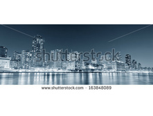Stock-photo-new-york-city-manhattan-midtown-skyline-black-and-white-at-night-over-east-river-163848089.jpg