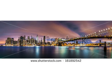 Stock-photo-lower-manhattan-and-the-brooklyn-bridge-under-a-cloudy-sky-at-dawn-as-viewed-from-the-brooklyn-161892542.jpg