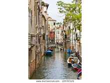 stock-photo-beautiful-view-of-traditional-venetian-buildings-along-a-water-channel-venice-italy-europe-105767129.jpg